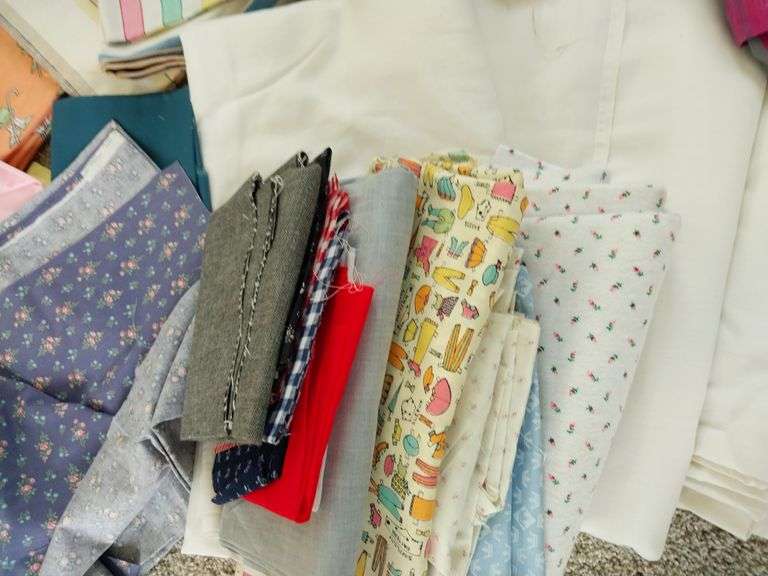 Large box of sewing material. Bolts of cloth. Curtains.