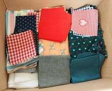 Large box of sewing material. Bolts of cloth. Curtains.