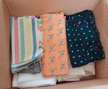 Large box of sewing material. Bolts of cloth. Curtains.
