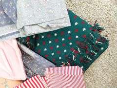 Large box of sewing material. Bolts of cloth. Curtains.