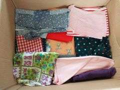 Large box of sewing material. Bolts of cloth. Curtains.