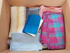 Large box of sewing material. Bolts of cloth. Curtains.