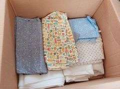 Large box of sewing material. Bolts of cloth. Curtains.