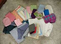 Large box of sewing material. Bolts of cloth. Curtains.