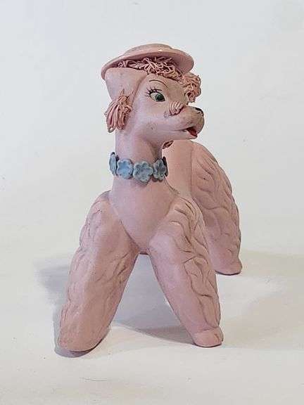 Pink spaghetti poodle with red striped hat