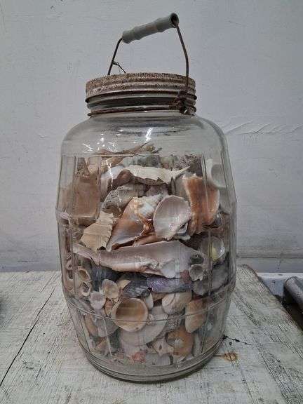 Large glass jar full of shells. 1c