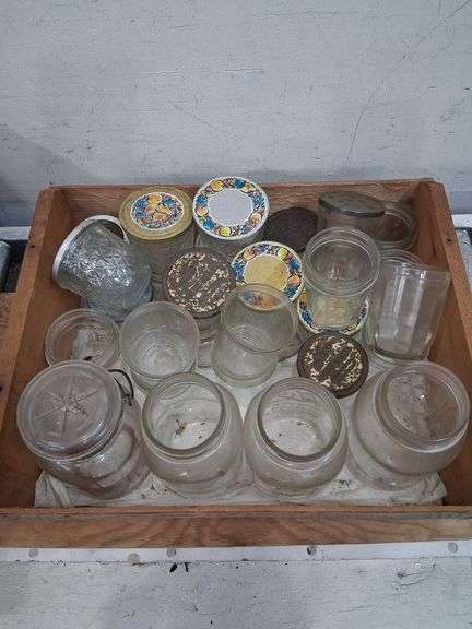 Vintage wooden CA grapes crate full of a variety of glass jars. 1e