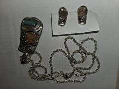 Silver chain, pendant, matching earings.