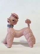 Pink spaghetti poodle with red striped hat