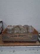 Vintage wooden CA grapes crate full of a variety of glass jars. 1e