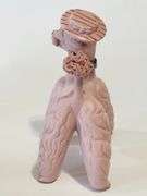 Pink spaghetti poodle with red striped hat