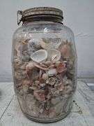 Large glass jar full of shells. 1c