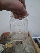Vintage wooden CA grapes crate full of a variety of glass jars. 1e
