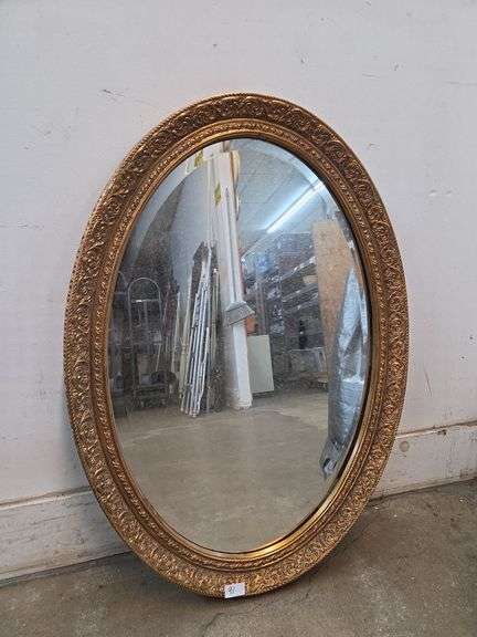 Ornate gold framed oval mirror