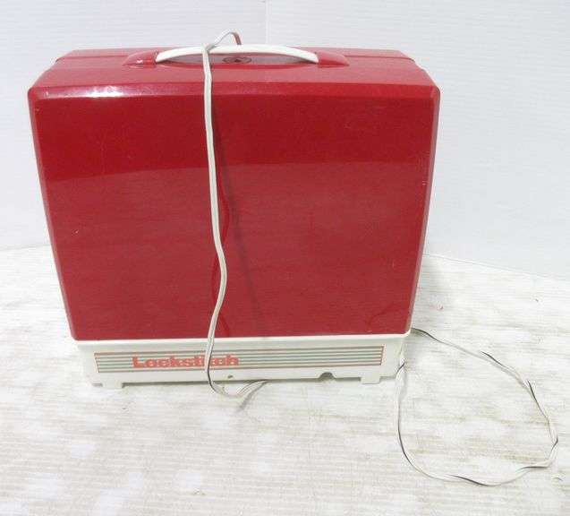Red and white Singer toy sewing machine, wheel brings needle up and down, spool for thread is