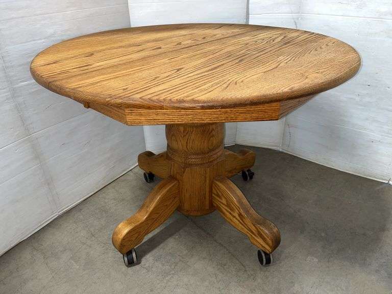 Oak table, 36"Dia, lock on the legs of the table, pull ring under the table which allows the table to separate and install a leaf, pedestal- 30"L