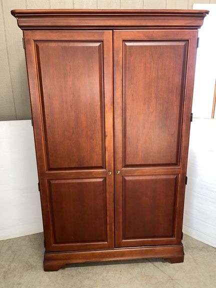 Self-storing office, 46"W x 24"D x 78"H, open storage with shelf on top half, drawers and open shelving on bottom, cherry colored finish cupboard, cord holes in back