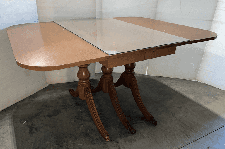 Older drop leaf dining room table, three-pedestal six-claw foot base, removable glass top center, 55 1/2"L x 42"W x 28 1/2"H, some finish loss to top