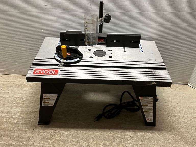 Ryobi 1 3/4 HP plunge router with a Ryobi RT101 router table, both in