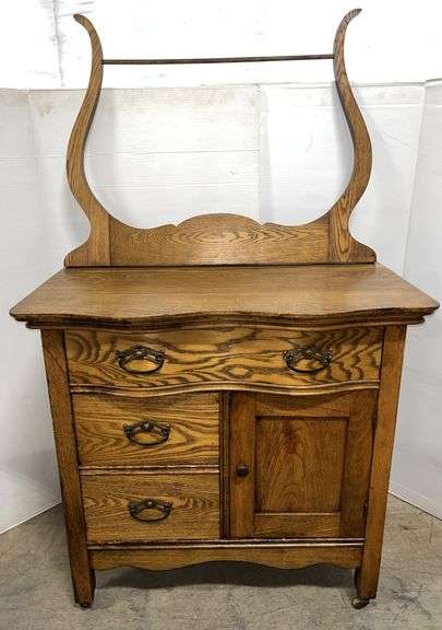 Oak washstand with towel rack, 32"W x 19"D x 31"H, missing wheel, otherwise good