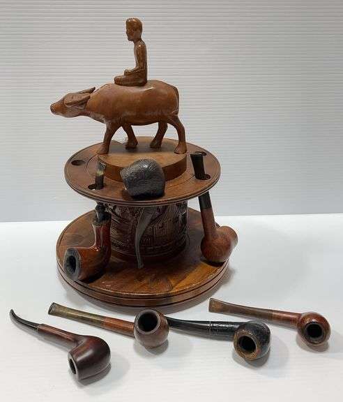 (7) Briar pipes in a 7-slot wooden pipe rack with carved center ...