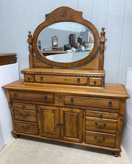 Solid wood ornate dresser with mirror, 9-pull-out drawers and 2-other pull-out drawers behind 2-swing-out doors, 68"W x 18"D x 72"H, used