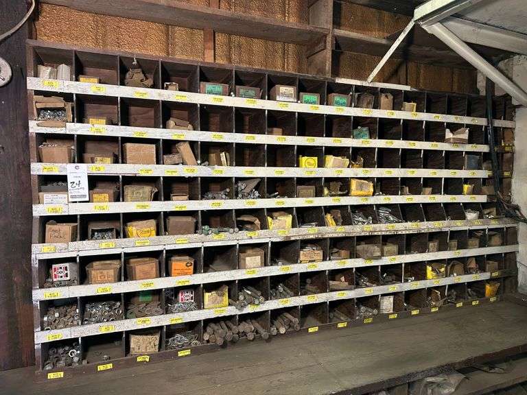 Wooden Parts Organizer Full of Nuts, Bolts and Washers from 1/4" to 3/4", Assorted Lengths.  Wood Organizer is Approx. 4' high x 101" wide.  Comes with Wooden Organizer but Not Sure How Easy it will Come Free of the Wall - Buyer's Responsibility to Remove.