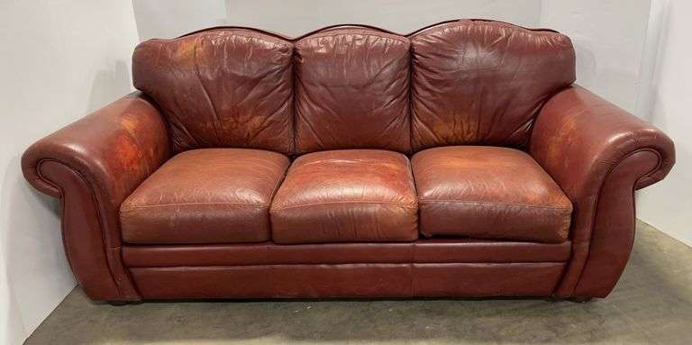 Dark red leather couch, velcro option cushions to remove, 7'W x 34"H, faded, holes, wear