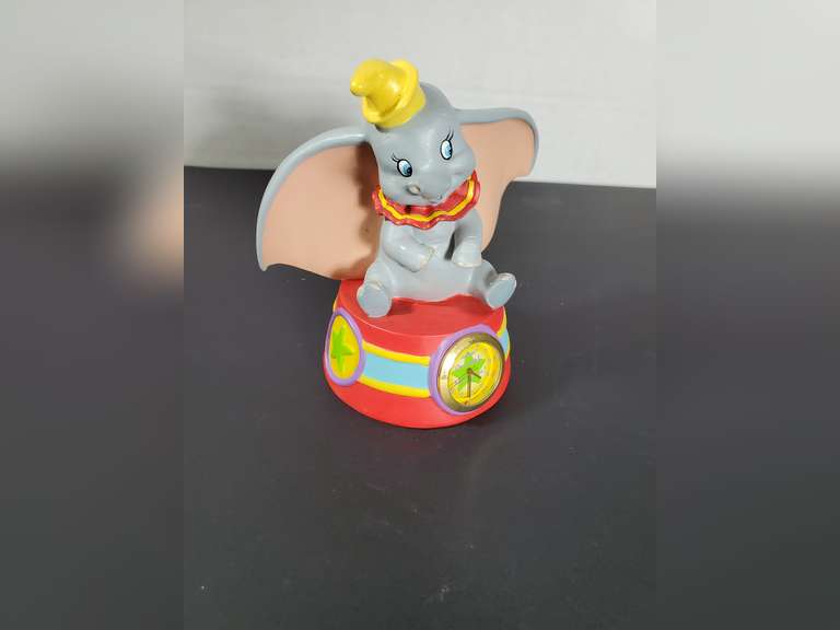 Fantasies Come True - Dumbo Figurine sitting on a Clock.