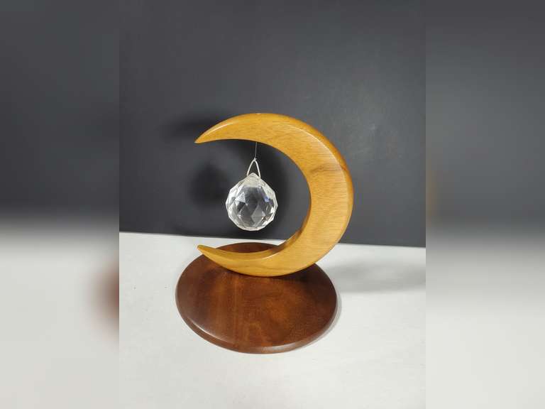 House of Myrtle Wood Sculpture Crescent Moon with a hanging Crystal.