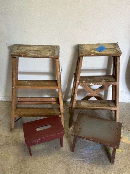 Two wooden step ladders with two stools