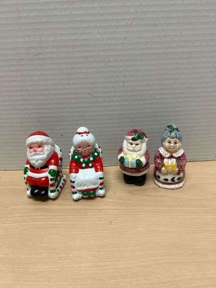 Four Santa And Mrs. Claus Ceramic Figurines With Holiday Colors