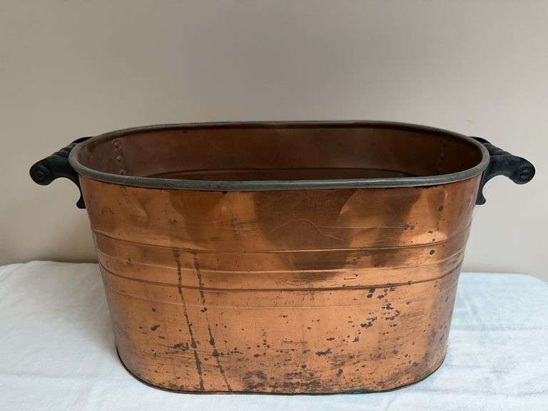 Oval copper bucket with wood handles