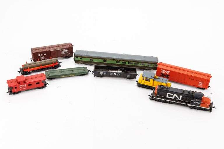 Seven HO Scale Model Train Cars and Two Locomotives