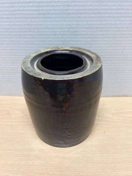 Black dark brown Glazed Stoneware Vessel With Visible Chips and Cracks on Rim and Base
