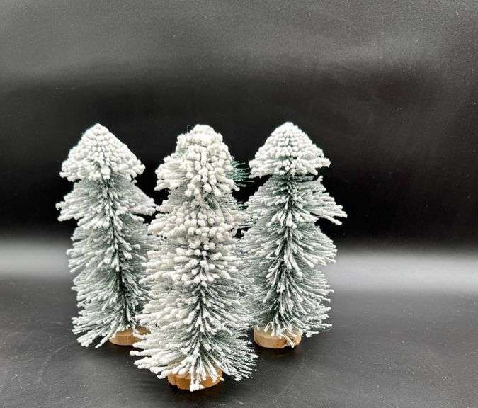 Four Snow-Flocked Bottle Brush Trees on Wooden Bases