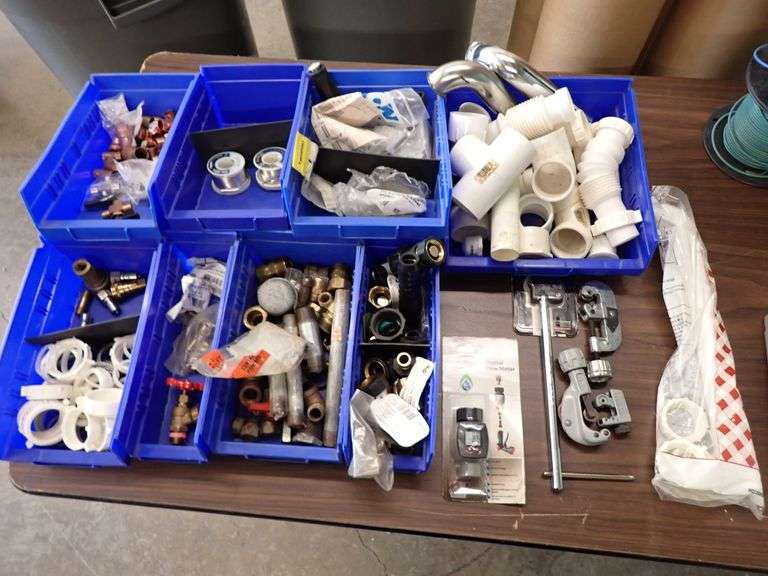 TABLE FILLED WITH NEW PLUMBING & HVAC SUPPLIES
