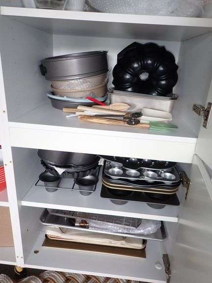 Bakers Cabinet filled with name brand cookware