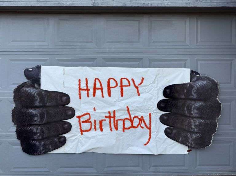 VERY LARGE!!! Gorilla Hands Holding Banner! This picture is taken on a garage door.