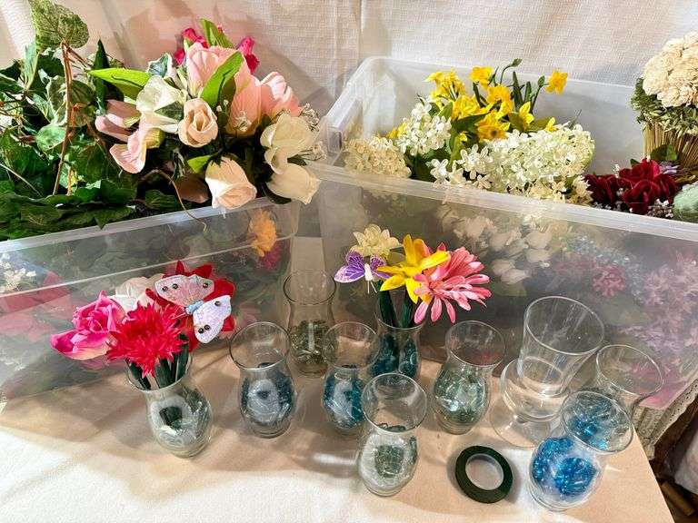 Totes Filled With Artificial Flowers And Glass Vases