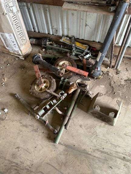 Tractor Parts Including Axles, Wheels, and Brackets