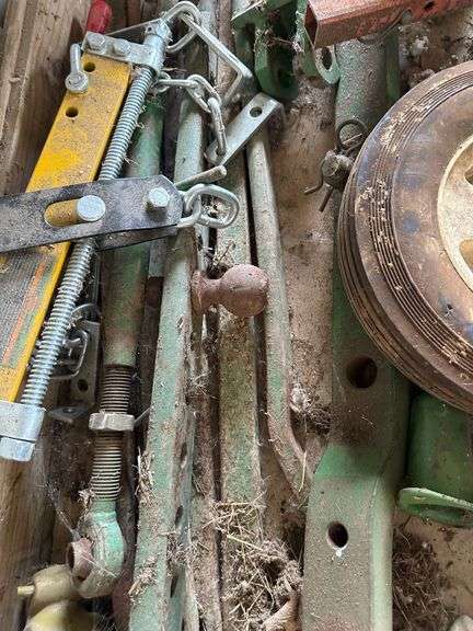 Tractor Parts Including Axles, Wheels, and Brackets