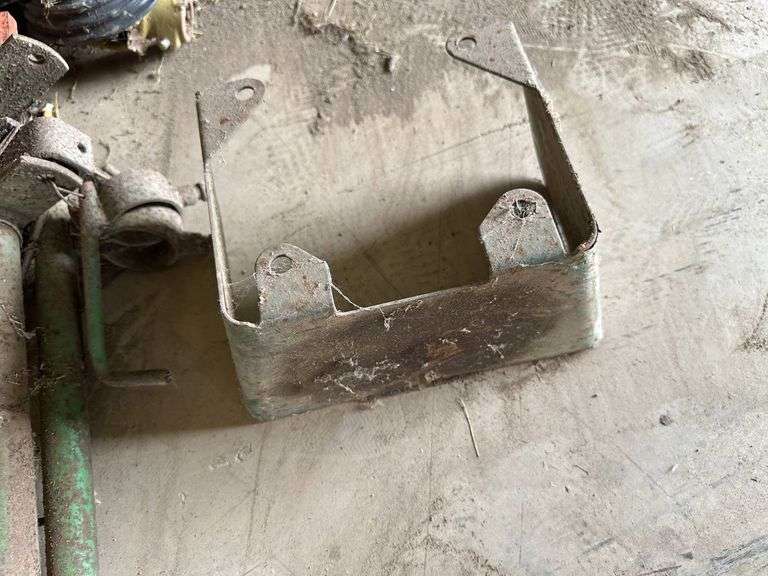 Tractor Parts Including Axles, Wheels, and Brackets