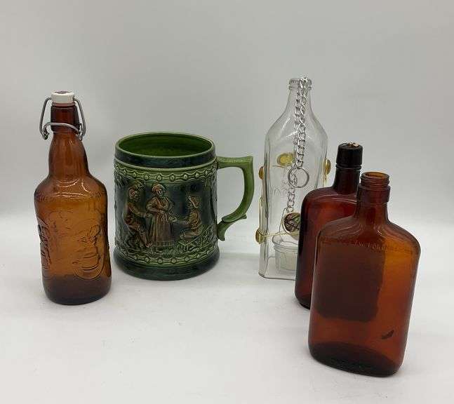 Assortment of Bottles and a Decorative Mug