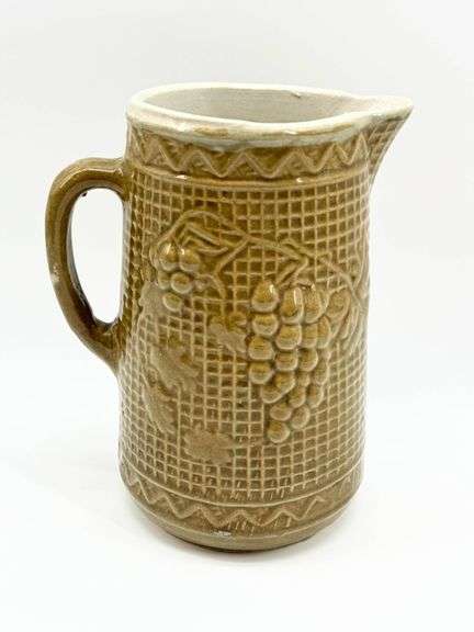 Brown Ceramic Pitcher with Grape Motif and Textured Design