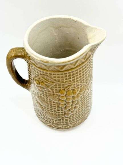 Brown Ceramic Pitcher with Grape Motif and Textured Design