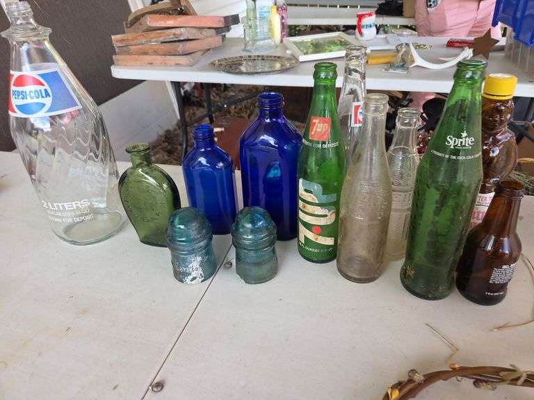 various empty glass collector bottles