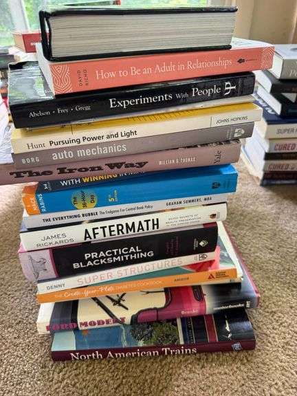 Stack of Mixed Books on Various Topics, Including Relationships, Mechanics, and History