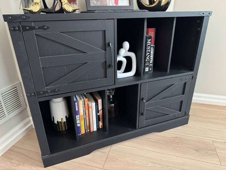 Black Wooden Cabinet With Sliding Barn-Style Doors and Open Shelves