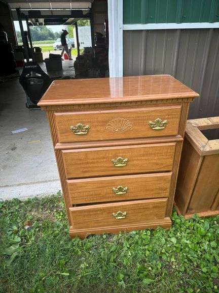 Four-Drawer Wood Dresser with Brass Handles and Decorative Carving